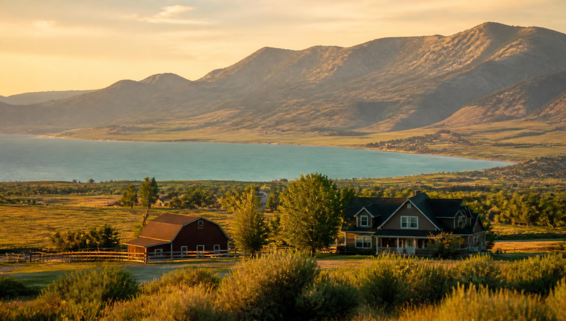 Ranch home and barn above Bear Lake at golden hour
